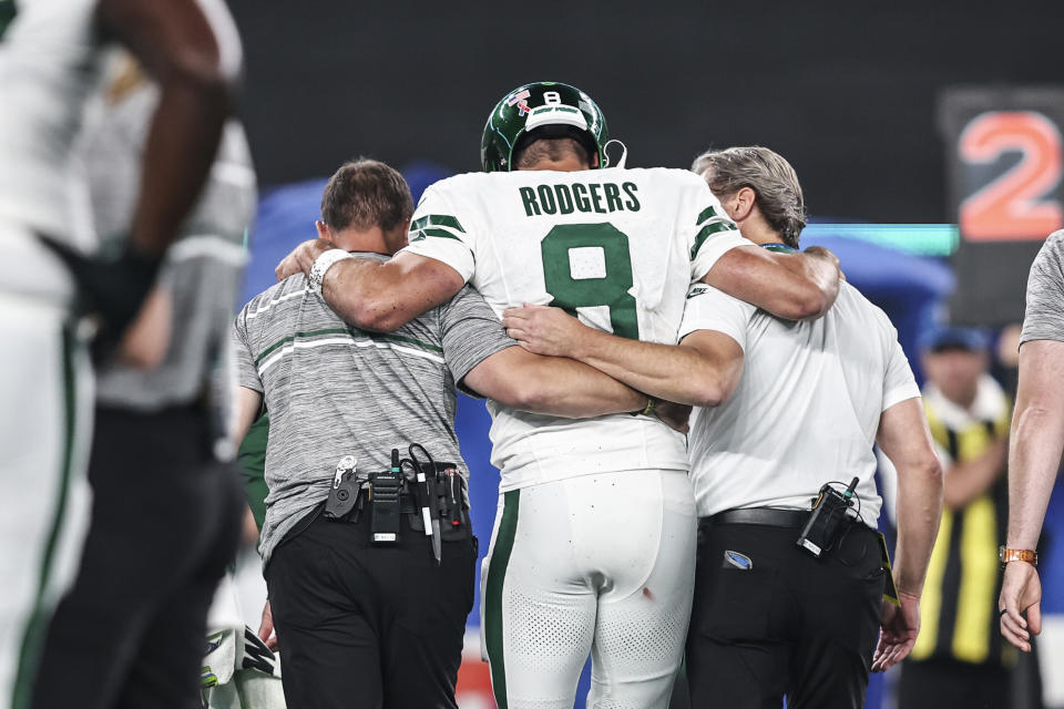 Aaron Rodgers of the New York Jets is helped off the field after suffering an apparent injury after being sacked by Leonard Floyd of the Buffalo Bills on Sept. 11, 2023, in East Rutherford, N.J. (Michael Owens / Getty Images)