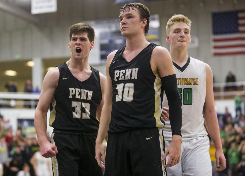 Penn’s Noah Applegate (30) reacts after scoring on a foul next to teammate Kegan Hoskins, left, and Northridge’s Alex Stauffer during the Class 4A regional championship high school basketball game on Saturday, March 9, 2019, at Michigan City High School.