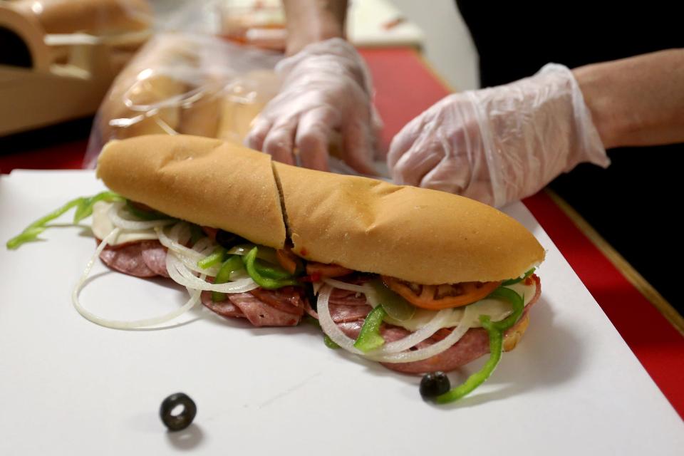 Owner Patti O’Leary makes sandwiches for the lunch rush on Feb. 1, 2022, at the Moe’s Italian Sandwiches in Exeter.