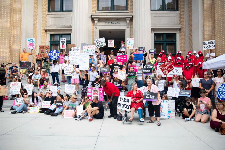 The crowd of protesters stand on the steps of the Old Lee County Courthouse to protest the overturning of Roe v. Wade on Friday, June 24, 2022 in Fort Myers, Fla.