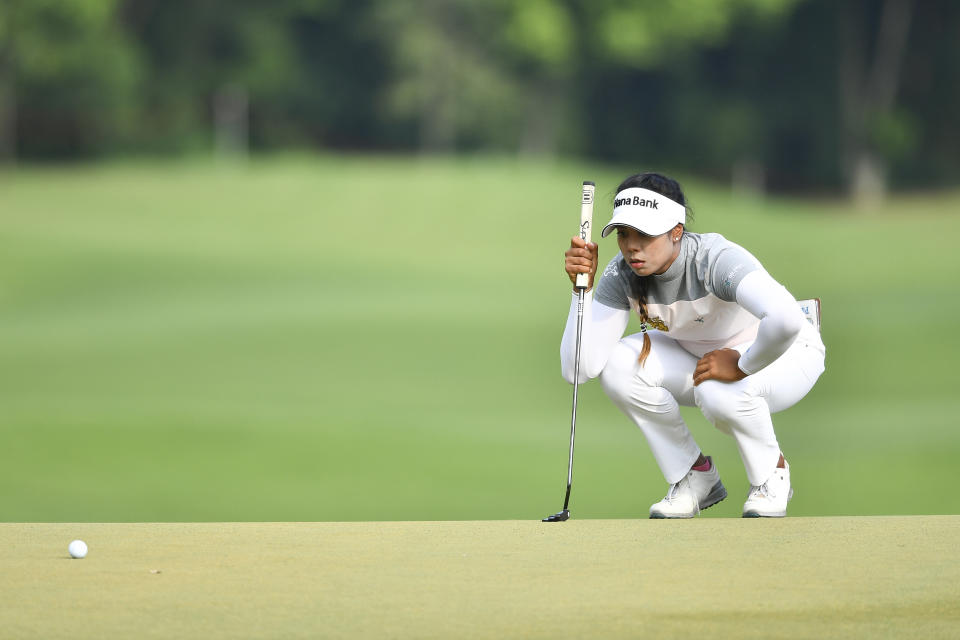 Patty Tavatanakit of Thailand lines up for a putt on the 18th hole during the final round of the LPGA Honda Thailand golf tournament in Pattaya, southern Thailand, Sunday, May 9, 2021. (AP Photo/Kittinun Rodsupan)