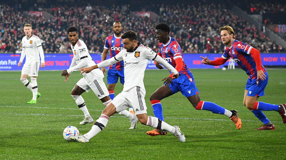 Manchester United's Bruno Fernandes is pictured trying to evade a Crystal Palace defender.