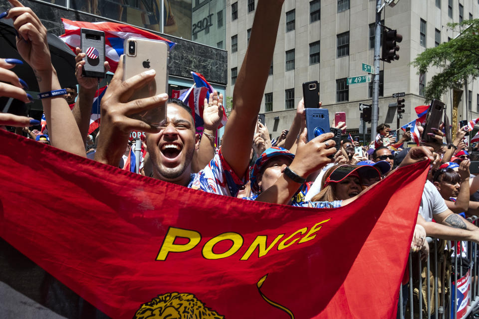 Spectators take part in the 62nd annual National Puerto Rican Day Parade Sunday, June 9, 2019, in New York. (AP Photo/Craig Ruttle)