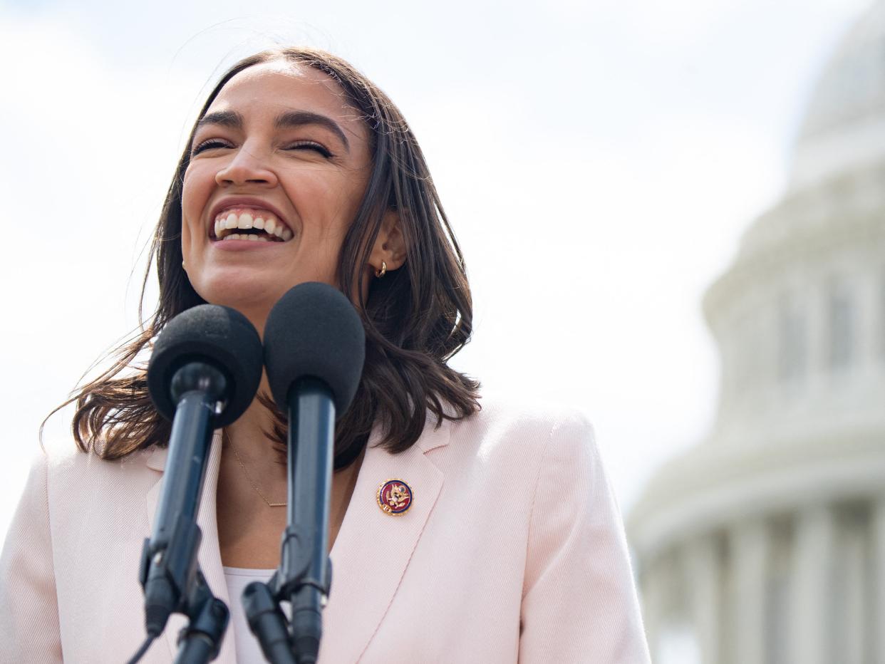 <p>US Representative Alexandria Ocasio-Cortez, Democrat of New York, attends a press conference about a postal banking pilot program outside the US Capitol in Washington, DC, 15 April, 2021</p> (AFP via Getty Images)