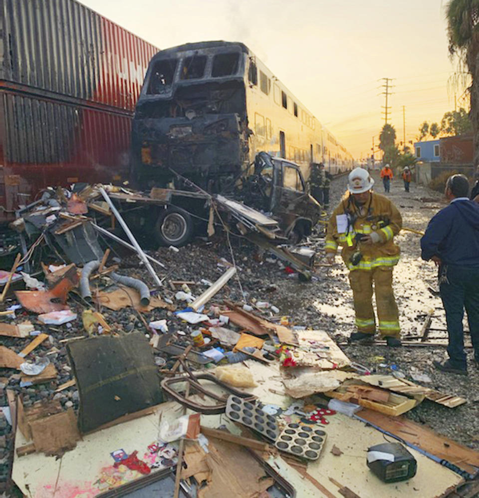 This photo provided by the Norwalk Sheriff's Station shows first responders at the scene after an RV was hit by a commuter train and burst into flames along a track in Santa Fe Springs, Calif., Friday, Nov. 22, 2019. Authorities say the collision occurred shortly after 5:30 a.m. Friday at an intersection in an industrial area of Santa Fe Springs. There were no immediate reports of injuries. All passengers on the Metrolink train were safely evacuated. (Norwalk Sheriff's Station via AP)