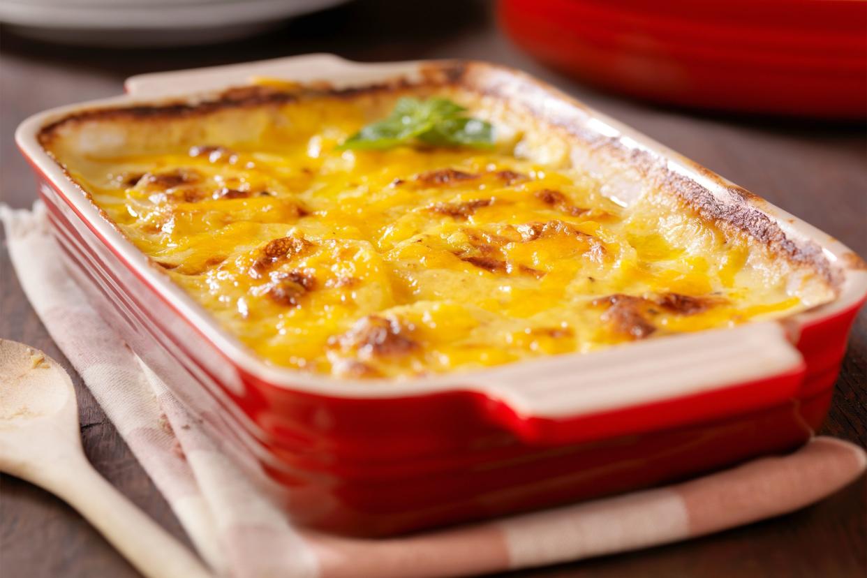 Cheese casserole in red ceramic baking dish