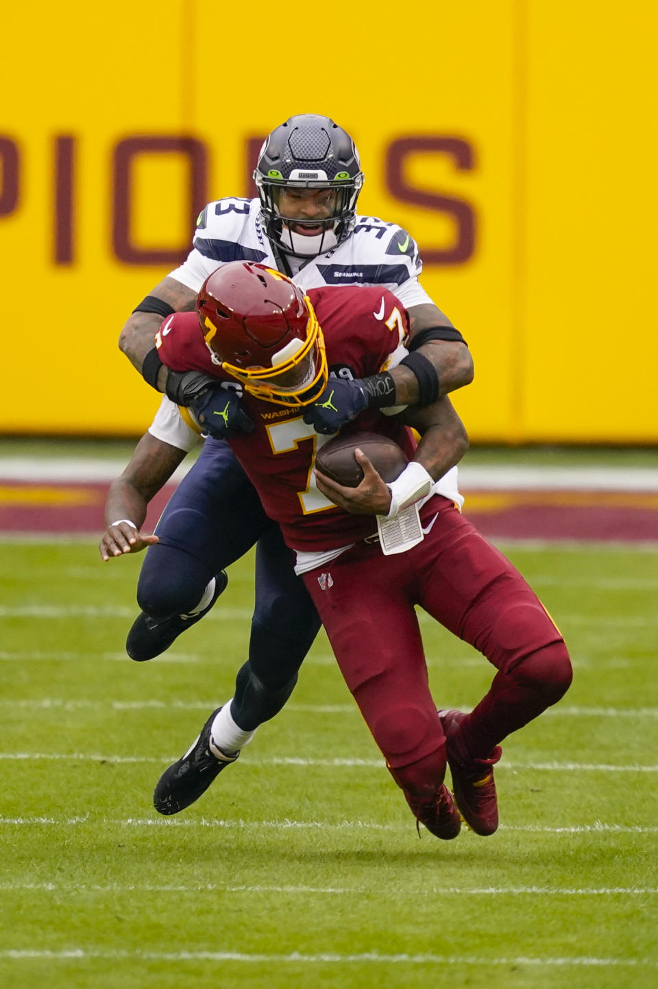 Washington Football Team quarterback Dwayne Haskins (7) is tackled by Seattle Seahawks strong safety Jamal Adams (33) during the first half of an NFL football game between the Seattle Seahawks and Washington Football Team, Sunday, Dec. 20, 2020, in Landover, Md. (AP Photo/Andrew Harnik)