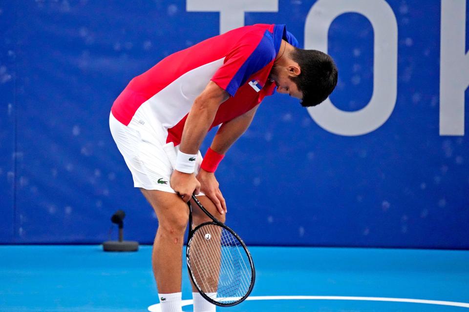 Novak Djokovic reacts after his loss to Pablo Carreno Busta.