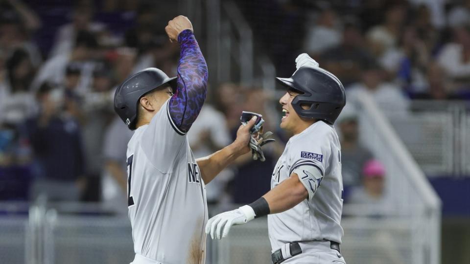 New York Yankees shortstop Anthony Volpe (right) celebrates with right fielder Giancarlo Stanton (27) after hitting a three-run home run against the Miami Marlins during the second inning at loanDepot Park.