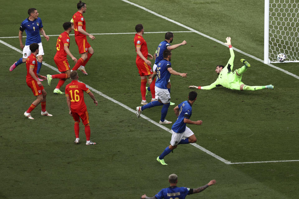 Italy's Matteo Pessina, center, scores his side's opening goal during the Euro 2020 soccer championship group A match between Italy and Wales at the Stadio Olimpico stadium in Rome, Sunday, June 20, 2021. (Ryan Pierse/Pool via AP)