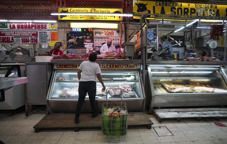 A woman shops for meat at a market in Mexico City, Tuesday, Aug. 9, 2022. Mexico's annual inflation rate rose to 8.15% in July, driven largely by the rising price of food, according to government data released Tuesday. (AP Photo/Fernando Llano)