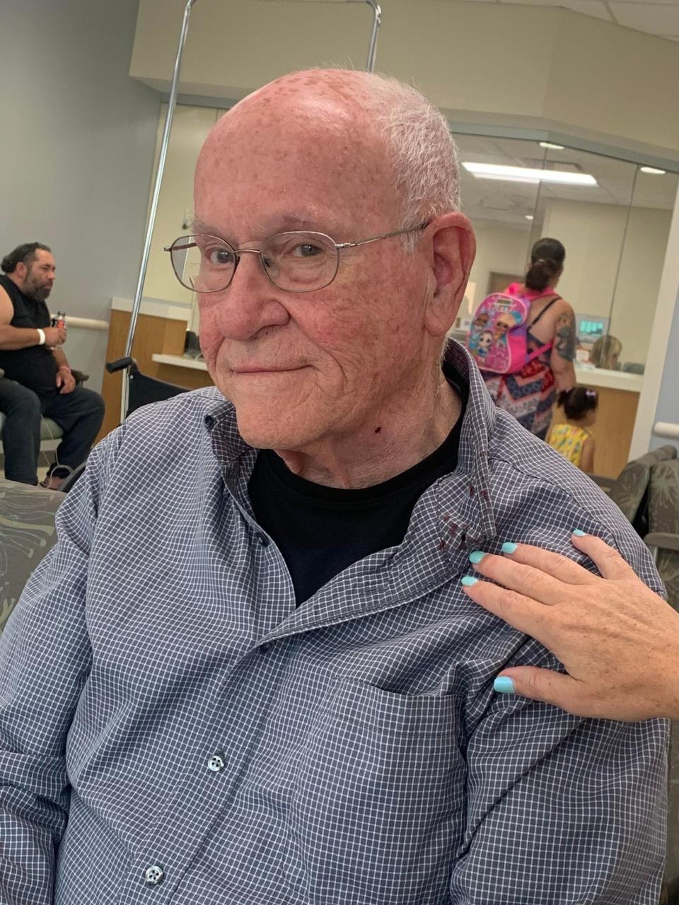 John Ridge, 83, sits in the waiting room before receiving care for a pointed pellet wound. While the pellet was lodged in his neck, it only left a small red mark.