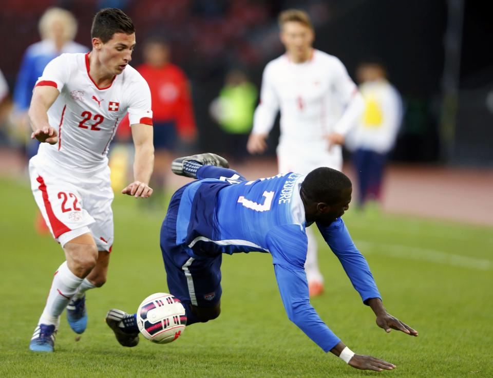 Altidore of the U.S falls next to Schar of Switzerland during their international friendly soccer match at the Letzigrund Stadium in Zurich