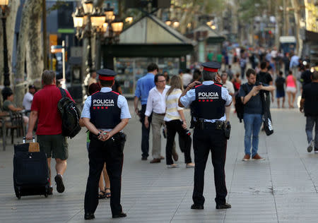 FILE PHOTO: Catalan Mossos d'esquadra officers patrol at Las Ramblas street where a van crashed into pedestrians in Barcelona, Spain August 18, 2017. REUTERS/Sergio Perez