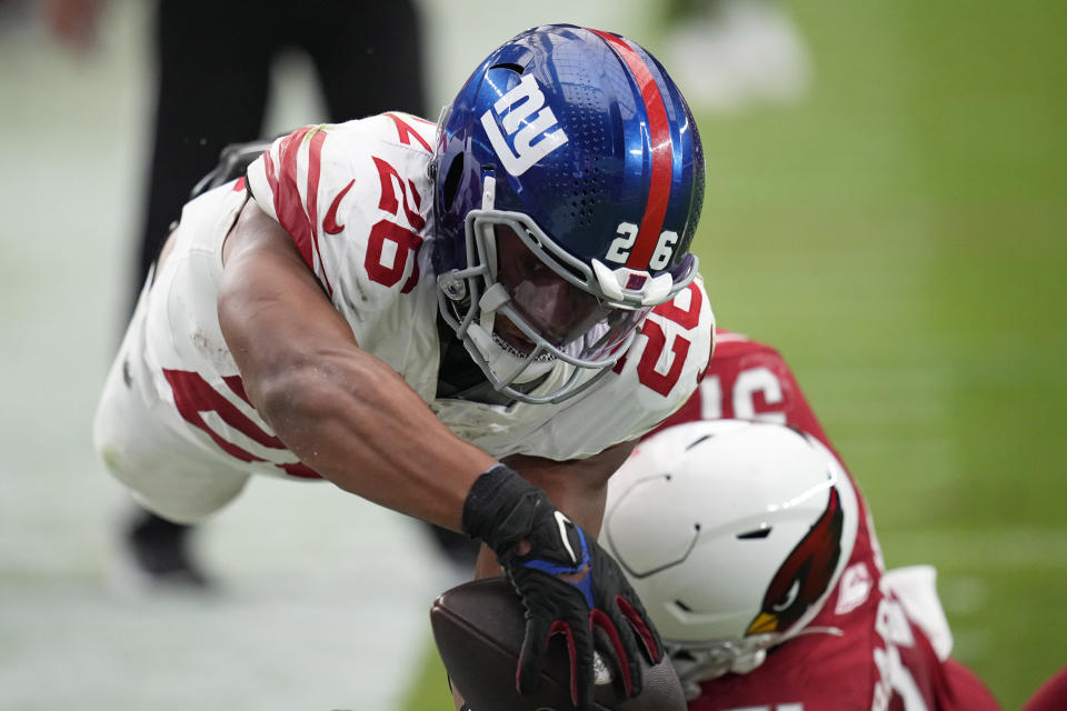 New York Giants running back Saquon Barkley (26) dives in for a touchdown against the Arizona Cardinals during the second half of an NFL football game, Sunday, Sept. 17, 2023, in Glendale, Ariz. (AP Photo/Ross D. Franklin)