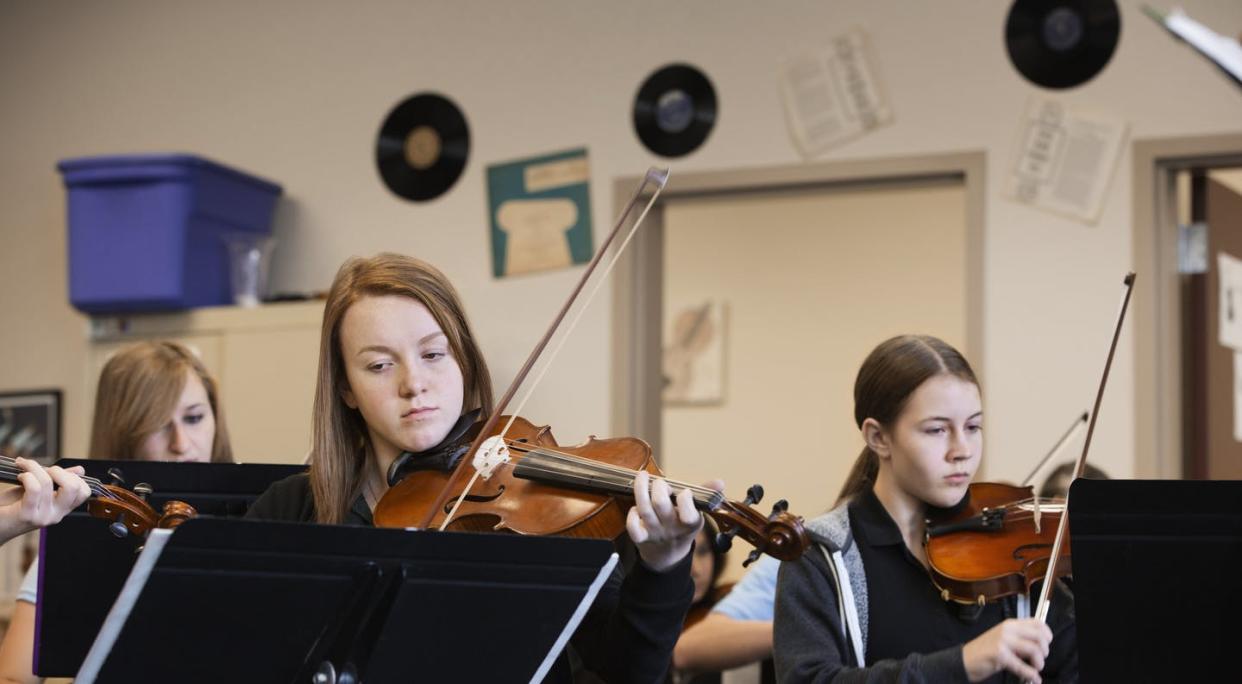 <span class="caption">College recruiters target high schools where kids are from well-off families.</span> <span class="attribution"><a class="link " href="https://www.gettyimages.com/detail/photo/caucasian-girls-playing-violin-in-music-class-royalty-free-image/519518257?adppopup=true" rel="nofollow noopener" target="_blank" data-ylk="slk:Hill Street Studios/Getty Images;elm:context_link;itc:0;sec:content-canvas">Hill Street Studios/Getty Images</a></span>