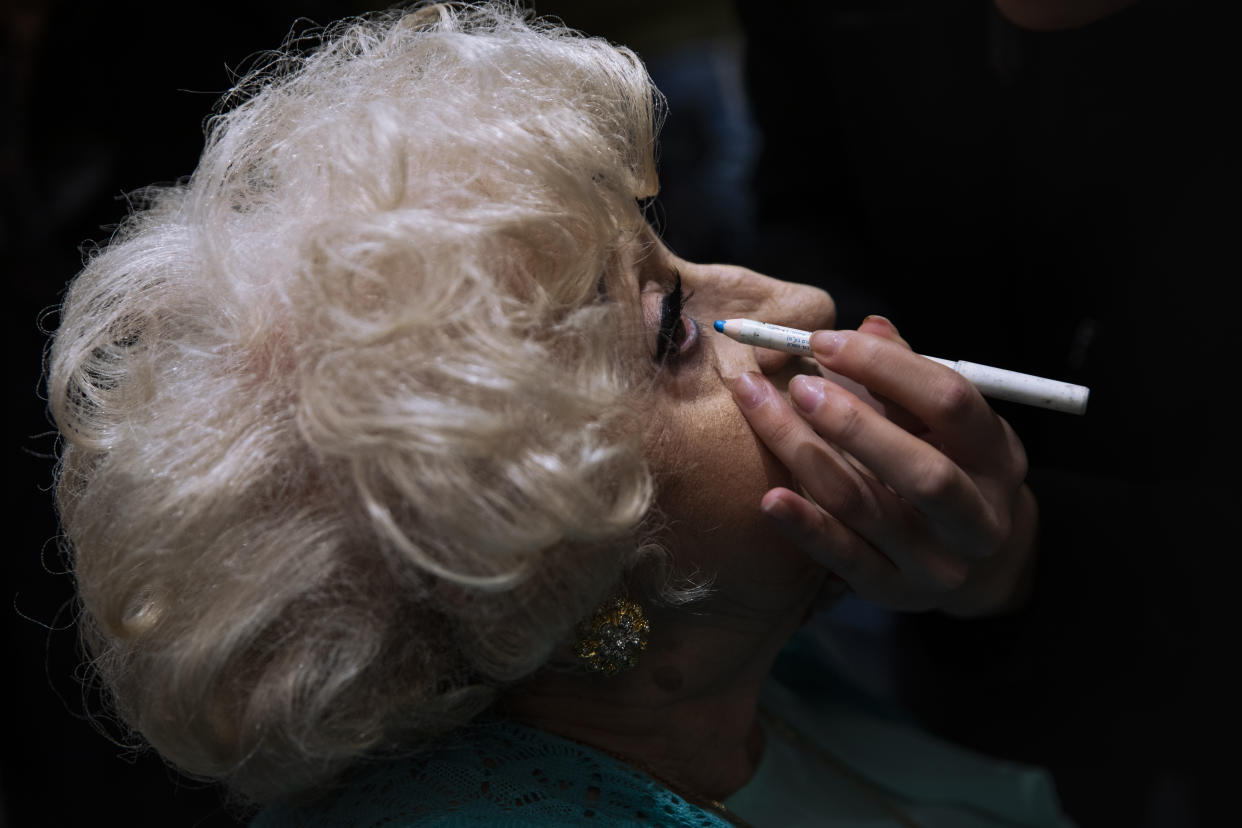 Holocaust survivor, Kuka Palmon, 87, gets make-up applied during a special beauty pageant honoring Holocaust survivors in Jerusalem, Tuesday, Nov. 16, 2021. Ten contestants participated in the "Miss Holocaust Survivor" pageant, which was held for the first time since 2019 after being suspended due to the coronavirus pandemic. (AP Photo/Oded Balilty)