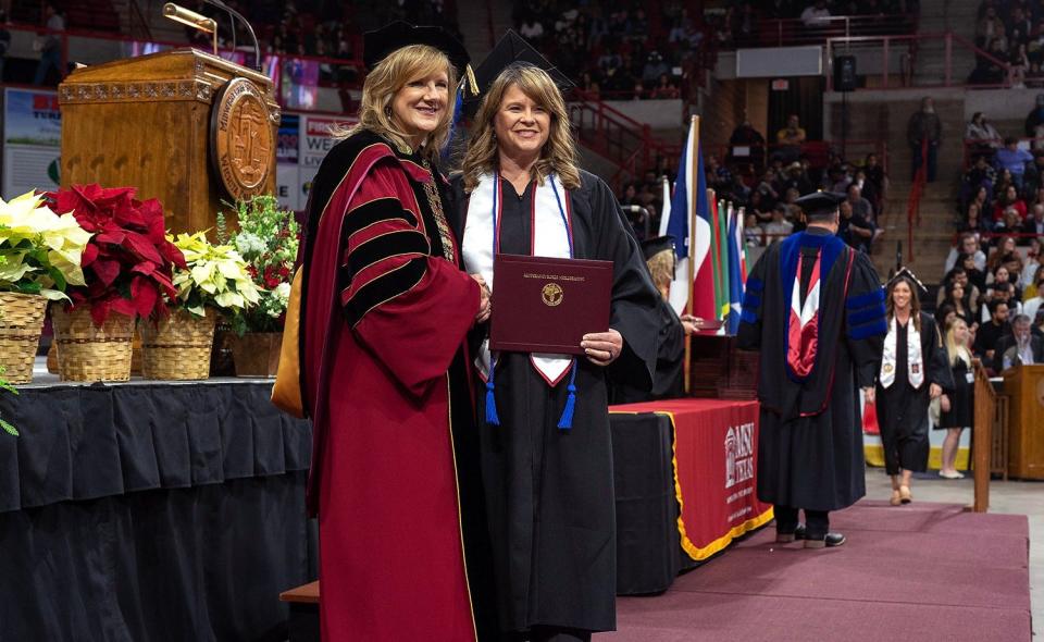 Kimberly Sieperda shakes hands with Dr. JuliAnn Mazachek, MSU Texas president, during the Dec. 10, 2022, graduation ceremony in the Kay Yeager Coliseum.