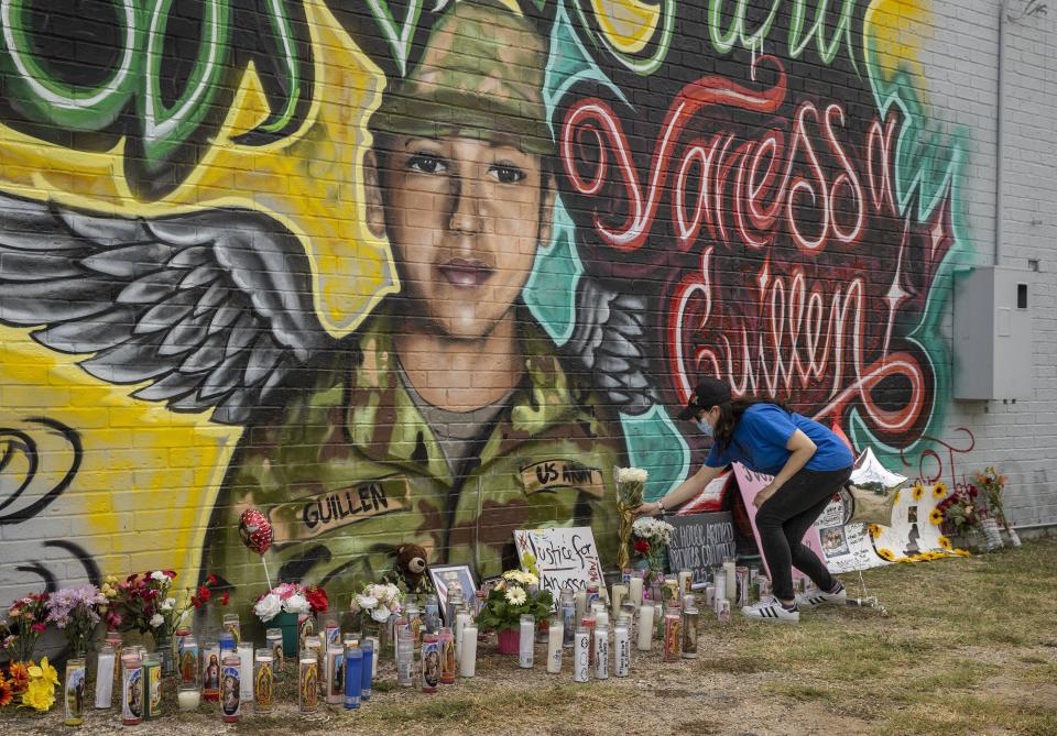 Mellisa Mendoza places flowers at a mural for Vanessa Guillen in Austin, Texas, on July 6, 2020.