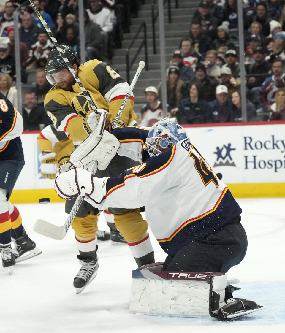 Colorado Avalanche goaltender Alexandar Georgiev, right, stops a shot as Vegas Golden Knights center Phil Kessel skates into him in the second period of an NHL hockey game Monday, Jan. 2, 2023, in Denver. (AP Photo/David Zalubowski)