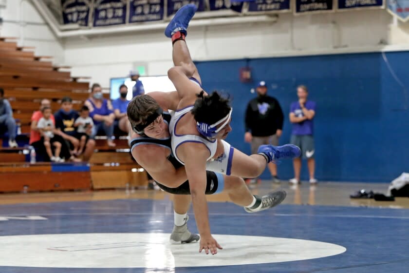 Corona del Mar's Dylan Wood, left, drops Western's Juan Orozco-Garcia to the mat during.