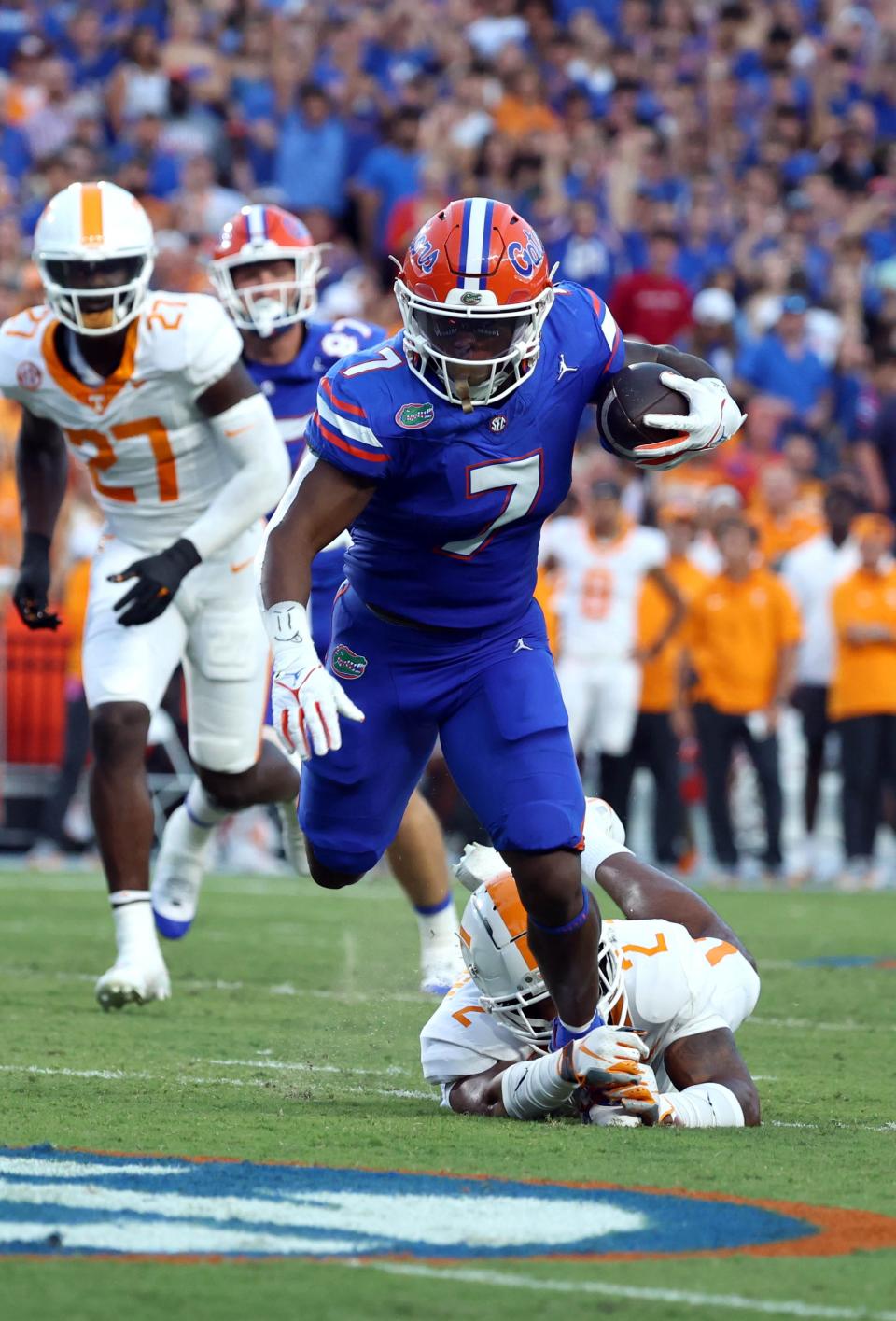 Sep 16, 2023; Gainesville, Florida, USA; Florida Gators running back Trevor Etienne (7) runs with the ball as Tennessee Volunteers defensive back Jaylen McCollough (2) tackles during the first quarter at Ben Hill Griffin Stadium. Mandatory Credit: Kim Klement Neitzel-USA TODAY Sports