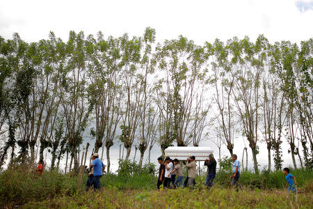 FILE PHOTO: Friend and family carry the coffin with the remains of Jakelin Caal, a 7-year-old girl who handed herself in to U.S. border agents earlier this month and died after developing a high fever while in the custody of U.S. Customs and Border Protection, during her funeral at her home village of San Antonio Secortez, in Guatemala December 25, 2018. Picture taken December 25, 2018. REUTERS/Carlos Barria - RC1C6B392D10/File Photo