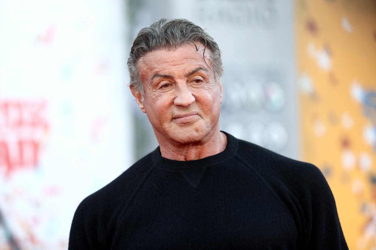 Sylvester Stallone in a black turtleneck