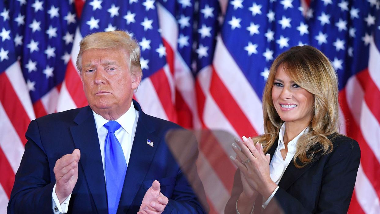 President Donald Trump claps alongside US First Lady Melania Trump after speaking during election night in the East Room of the White House in Washington, DC, early on November 4, 2020