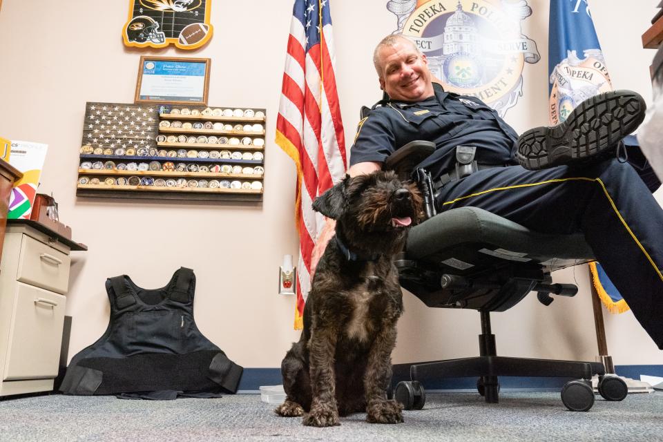 D-O-G gets a nice pet from his owner, Topeka Police Chief Bryan Wheeles inside his office Tuesday. Wheeles says the name came from two of his children and is pronounced "Dee-Oh-Gee."