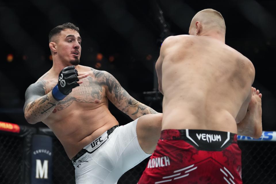 England's Tom Aspinall, left, kicks Russia's Sergei Pavlovich during the first round of a heavyweight title bout at the UFC 295 mixed martial arts event Saturday, Nov. 11, 2023, in New York. Aspinall stopped Pavlovich in the first round. (AP Photo/Frank Franklin II)