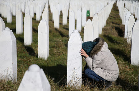 A woman reacts near a grave of her family members in the Memorial centre Potocari near Srebrenica, Bosnia and Herzegovina, after the court proceedings of former Bosnian Serb general Ratko Mladic, November 22, 2017. REUTERS/Dado Ruvic