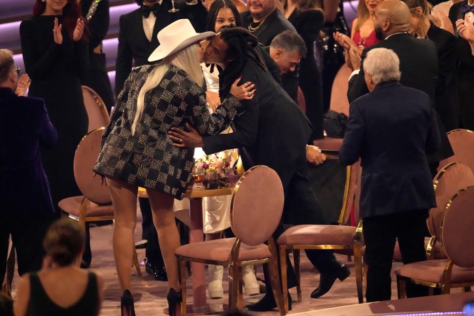 Beyoncé, left, and Jay-Z kiss in the audience as Jay-Z is given the Dr. Dre Global Impact Award during the 66th annual Grammy Awards on Feb. 4, 2024, in Los Angeles.