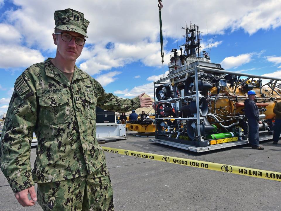 A member of the US Navy walks by the pressurized-rescue module, which would take part in the search-and-rescue efforts of the missing submarine ARA San Juan.