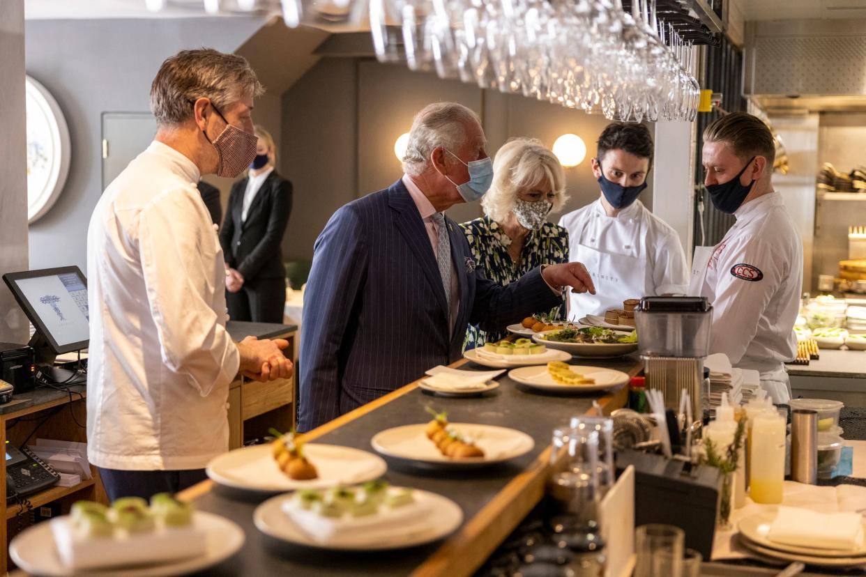 Britain's Prince Charles, Prince of Wales and Britain's Camilla, Duchess of Cornwall visit Trinity Restaurant Clapham during their visit to Clapham Old Town, south London on May 27, 2021. (Photo by Heathcliff O'Malley / POOL / AFP) (Photo by HEATHCLIFF O'MALLEY/POOL/AFP via Getty Images)