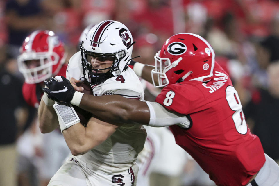 South Carolina quarterback Luke Doty (4) is tackled by Georgia linebacker MJ Sherman (8) during the second half of an NCAA college football game Saturday, Sept. 18, 2021, in Athens, Ga. Georgia won 40-13. (AP Photo/Butch Dill)