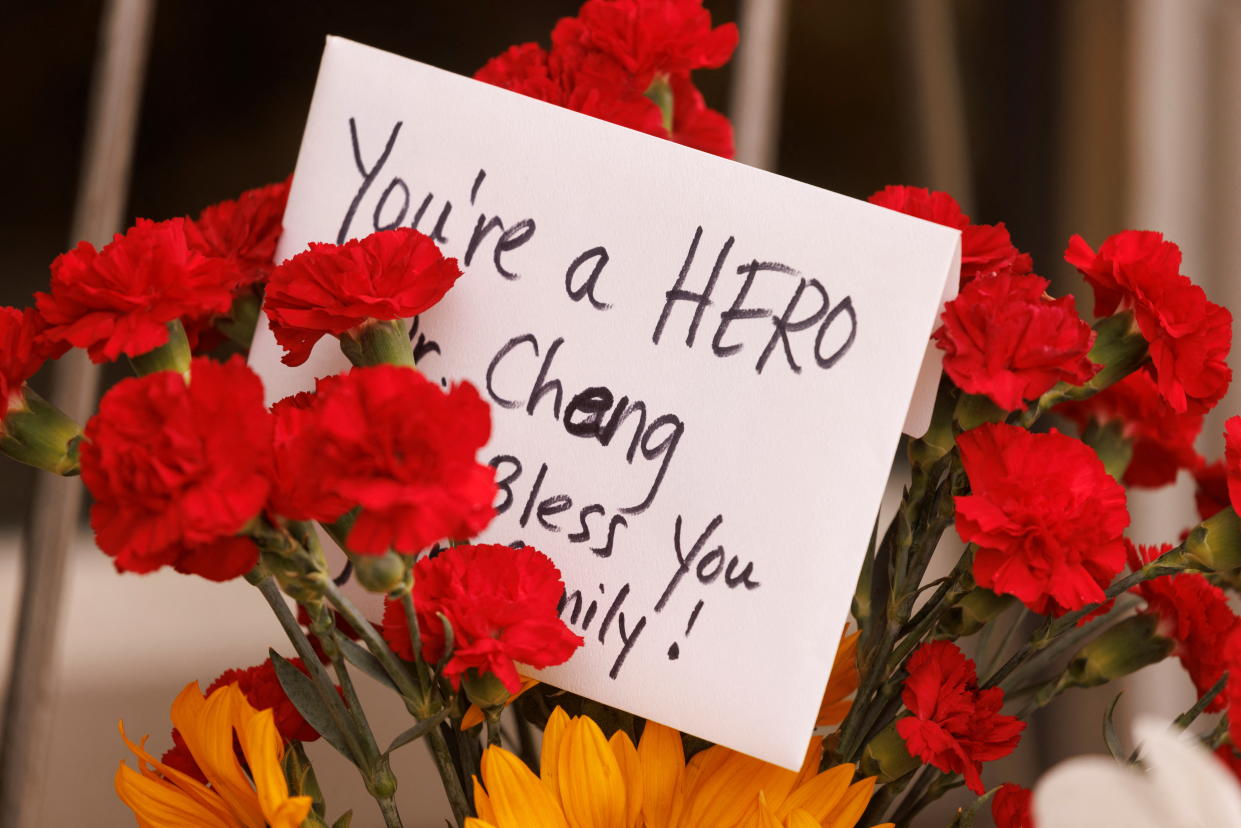 A message is seen at a memorial outside the entrance to the building where Dr. John Cheng, a 52-year-old victim who was killed in Sunday's shooting at Geneva Presbyterian Church, worked in Aliso Viejo, California, U.S. May 17, 2022.    REUTERS/Mike Blake