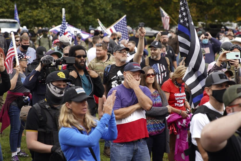 Members of the Proud Boys and other right-wing demonstrators rally, Saturday, Sept. 26, 2020, in Portland, Ore. (AP Photo/Allison Dinner)