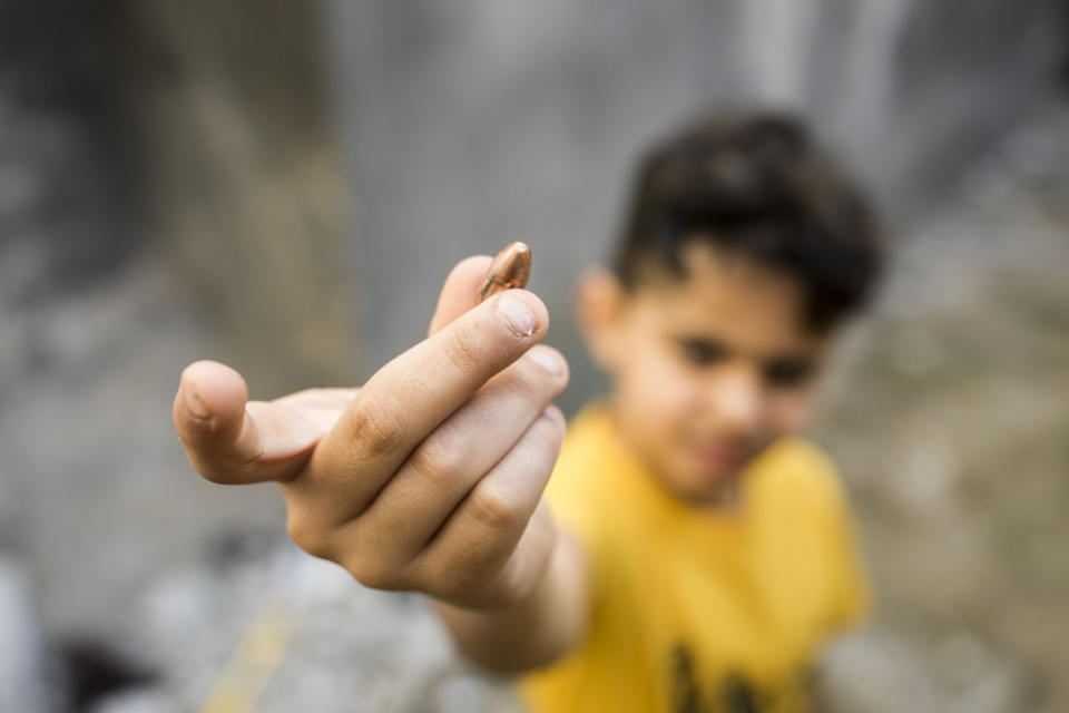 A boy shows a bullet after a military raid in the Nur Shams refugee camp near the city of Tulkarem, in the occupied West Bank Saturday, May 6, 2023. Israeli forces shot dead two Palestinians during a military raid in the occupied West Bank Saturday, the Palestinian Health Ministry said, while a local armed group said the pair were militants.The ministry and Tulkarem's branch of Al Aqsa Martyrs Brigades, a militant group with connections to President Mahmoud Abbas' Fatah party, identified the pair as Samer El Shafei and Hamza Kharyoush, both aged 22 years. (AP Photo/Majdi Mohammed)