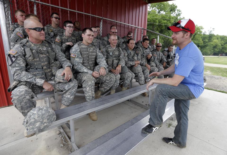 NASCAR driver Dale Earnhardt Jr., talks with soldiers after firing a M4 Rifle at Camp Atterbury Wednesday, July 23, 2014, in Edinburgh, Ind. (AP Photo/Darron Cummings)