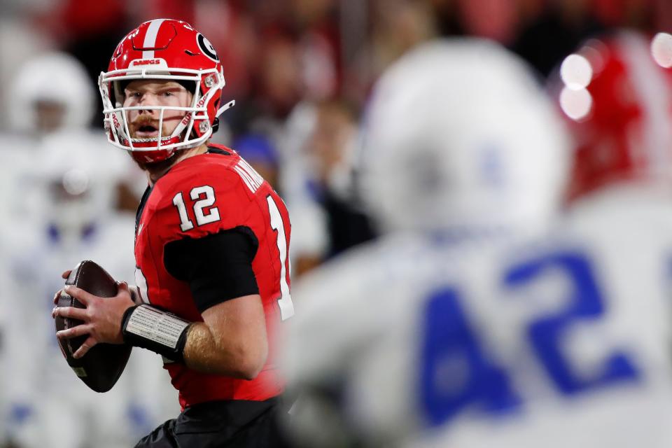 Georgia quarterback Brock Vandagriff (12) looks for an open pass during the second half of a NCAA college football game against Kentucky in Athens, Ga., on Saturday, Oct. 7, 2023.