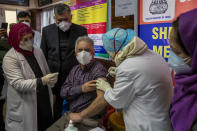 A Kashmiri doctor receives a COVID-19 vaccine at a government Hospital in Srinagar, Indian controlled Kashmir, Saturday, Jan. 16, 2021. India started inoculating health workers Saturday in what is likely the world's largest COVID-19 vaccination campaign, joining the ranks of wealthier nations where the effort is already well underway. (AP Photo/ Dar Yasin)