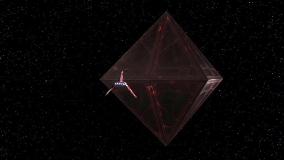 A space ship flies towards a giant black and red monolith that resembles two pyramids stacked opposite one another on The Clone Wars