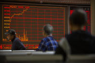Chinese investors monitor stock prices at a brokerage house in Beijing, Tuesday, Nov. 19, 2019. Asian shares were mixed Tuesday as investor sentiment remained cautious amid worries about the next development in trade talks between the United States and China. (AP Photo/Mark Schiefelbein)