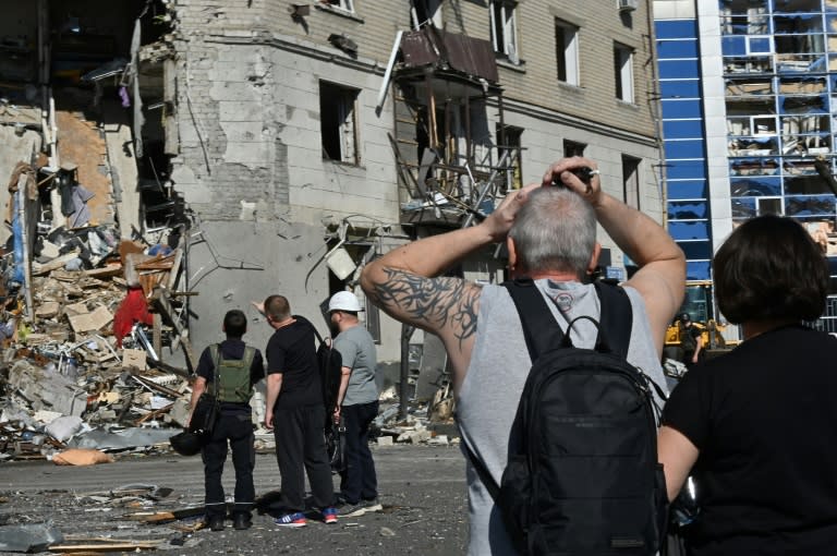 An aerial bomb hit an apartment block in the Ukrainian city of Kharkiv in Russia's latest deadly attack (SERGEY BOBOK)