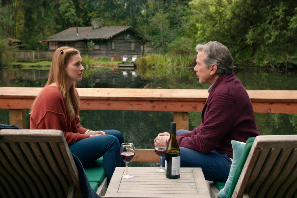 ALEXANDRA BRECKENRIDGE as MEL MONROE and TIM MATHESON as DOC MULLINS sat next to Mel's cabin in Virgin River