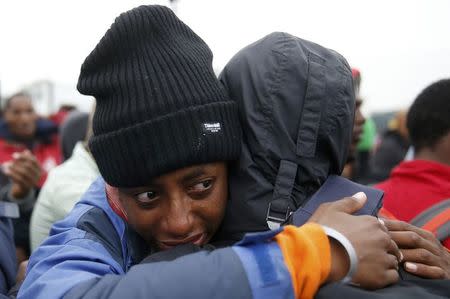 An Ethiopian migrant, member of the Oromo community, cries as he leaves the "Jungle" to be transfered to reception centers during the start of the dismantlement of the camp in Calais, France, October 24, 2016. REUTERS/Pascal Rossignol