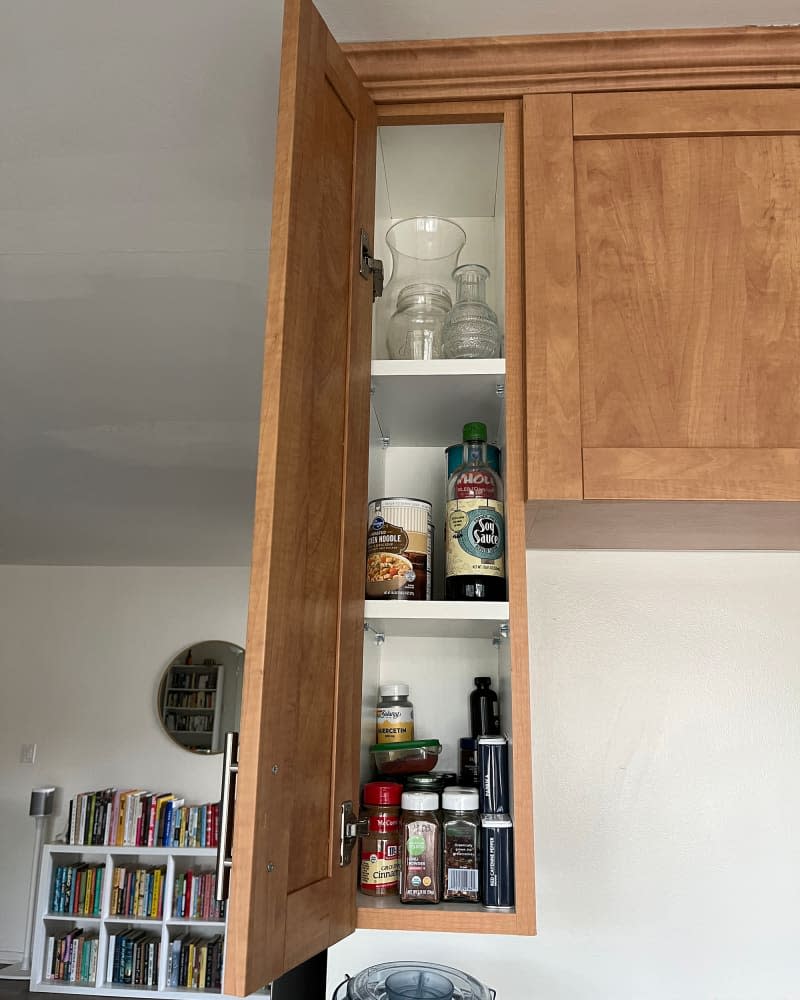 Kitchen spice cabinet before organization.