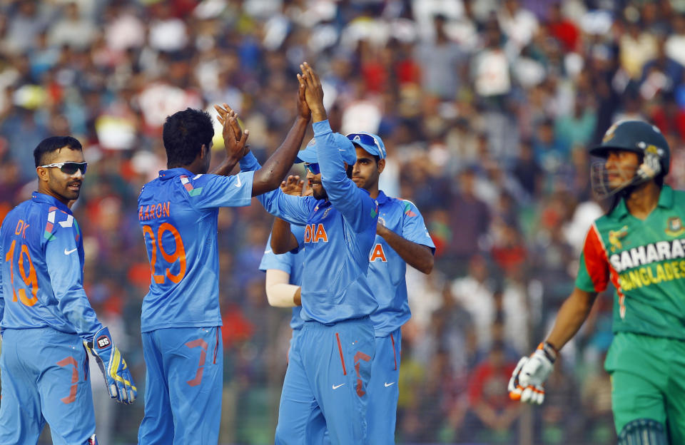 India’s Varun Aaron, second left, celebrates with teammates the dismissal of Bangladesh’s Anamul Haque during the Asia Cup one-day international cricket tournament in Fatullah, near Dhaka, Bangladesh, Wednesday, Feb. 26, 2014. (AP Photo/A.M. Ahad)