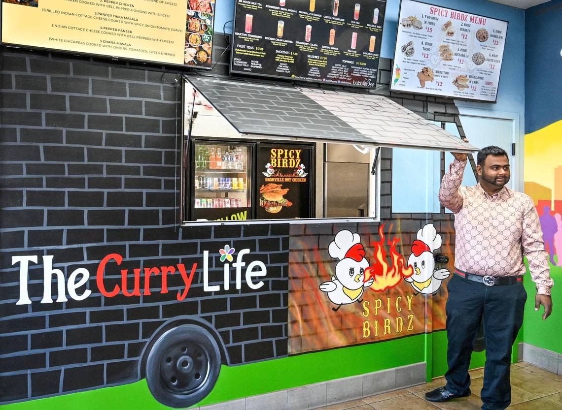 Smit Shah of The Curry Life opens the door to the ordering window at the Indian eatery’s new brick-and-mortar location shared with Spicy Birdz and bubble Bee boba drinks in the Bluff View shopping center at Herndon and West in Fresno on Wednesday, Feb. 15, 2023.